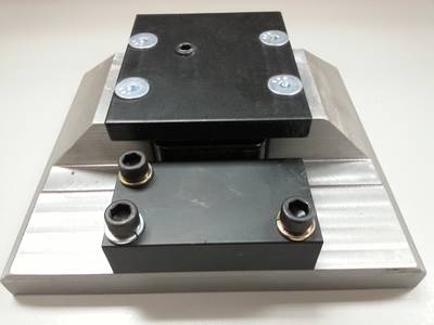 Mounting Block – Front: Front face of mounting block with lock cover plate top, and     snubber bar block bottom.